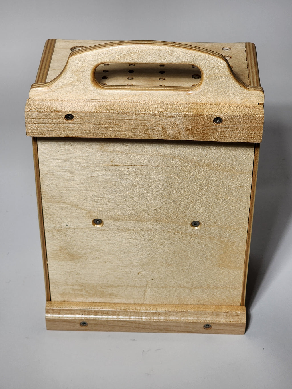 Back view of a handcrafted wooden CUSTOMadera tool organizer showing the handle, French cleat mounting system, and durable wood construction.