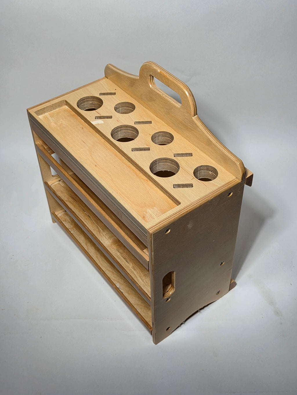 Rear angled view of the Cocina™ Chef Caddy handcrafted wooden kitchen utensil organizer featuring integrated carry handles and multiple storage shelves.