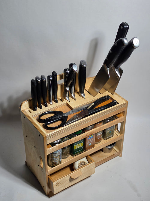 Wooden kitchen utensil organizer shown with knives, spices, shears, and cooking tools, designed for countertop placement or wall mounting in a kitchen workspace