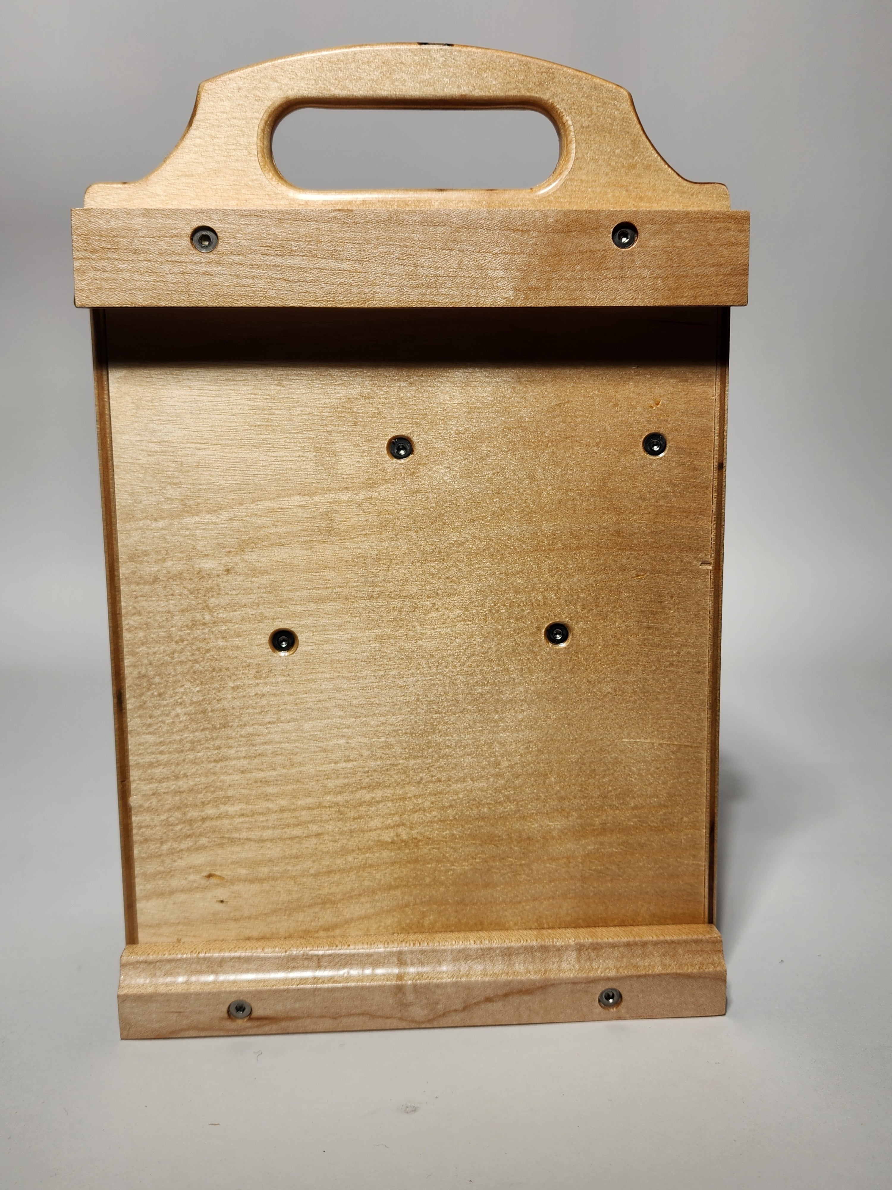 Back view of the El Apoyo CNC™ Small CNC Bit Organizer, showing the handcrafted wooden construction, integrated carry handle opening, visible fasteners, rear support panel, and wall cleat area for storing the compact caddy when not in use.