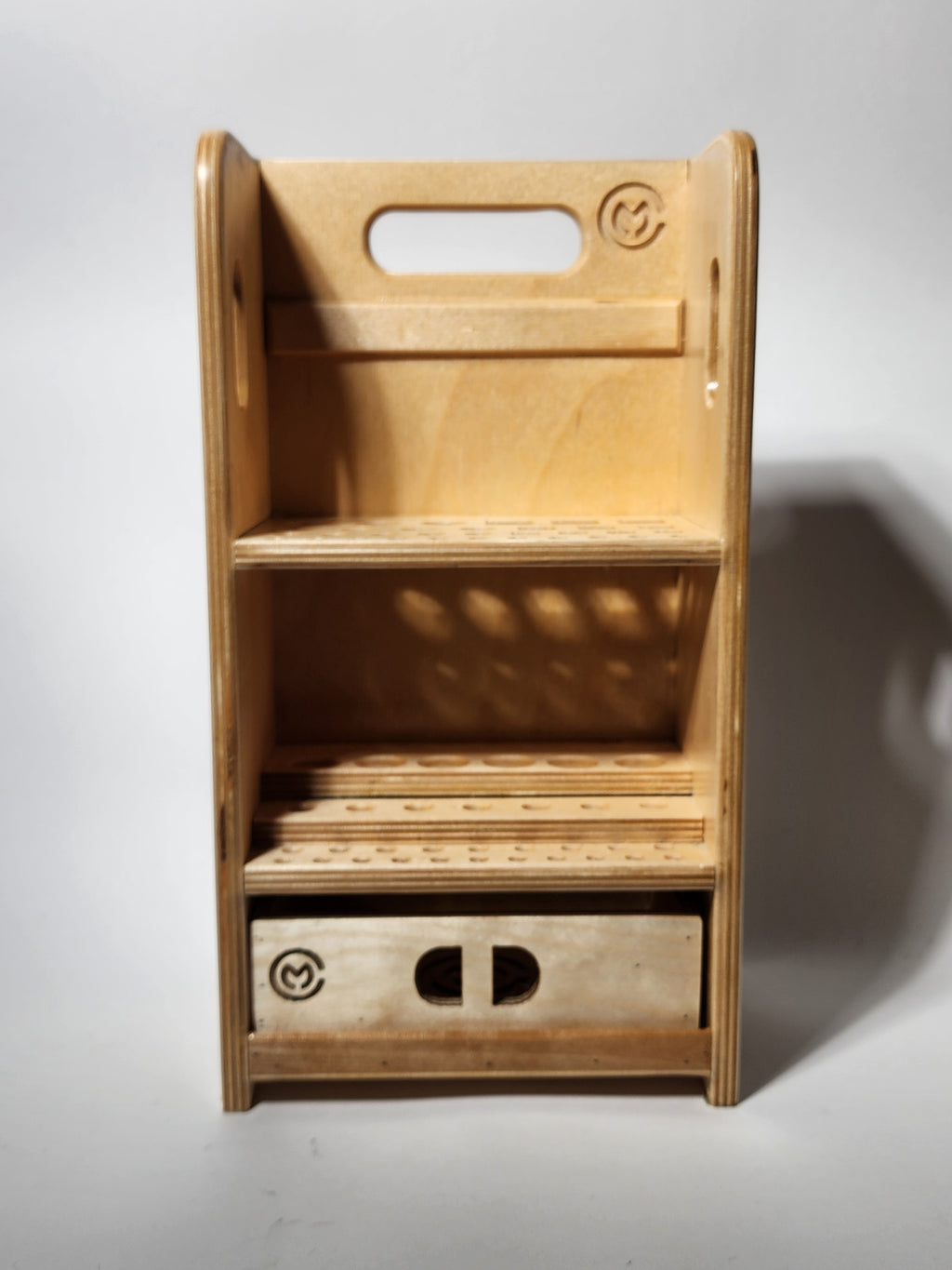 Front view of the El Compañero™ Small General Tool Organizer, a compact handcrafted wooden caddy with vertical tool storage, stepped interior compartments, exposed layered wood edges, CUSTOMadera branding, and a lower drawer for accessories or small workshop supplies.